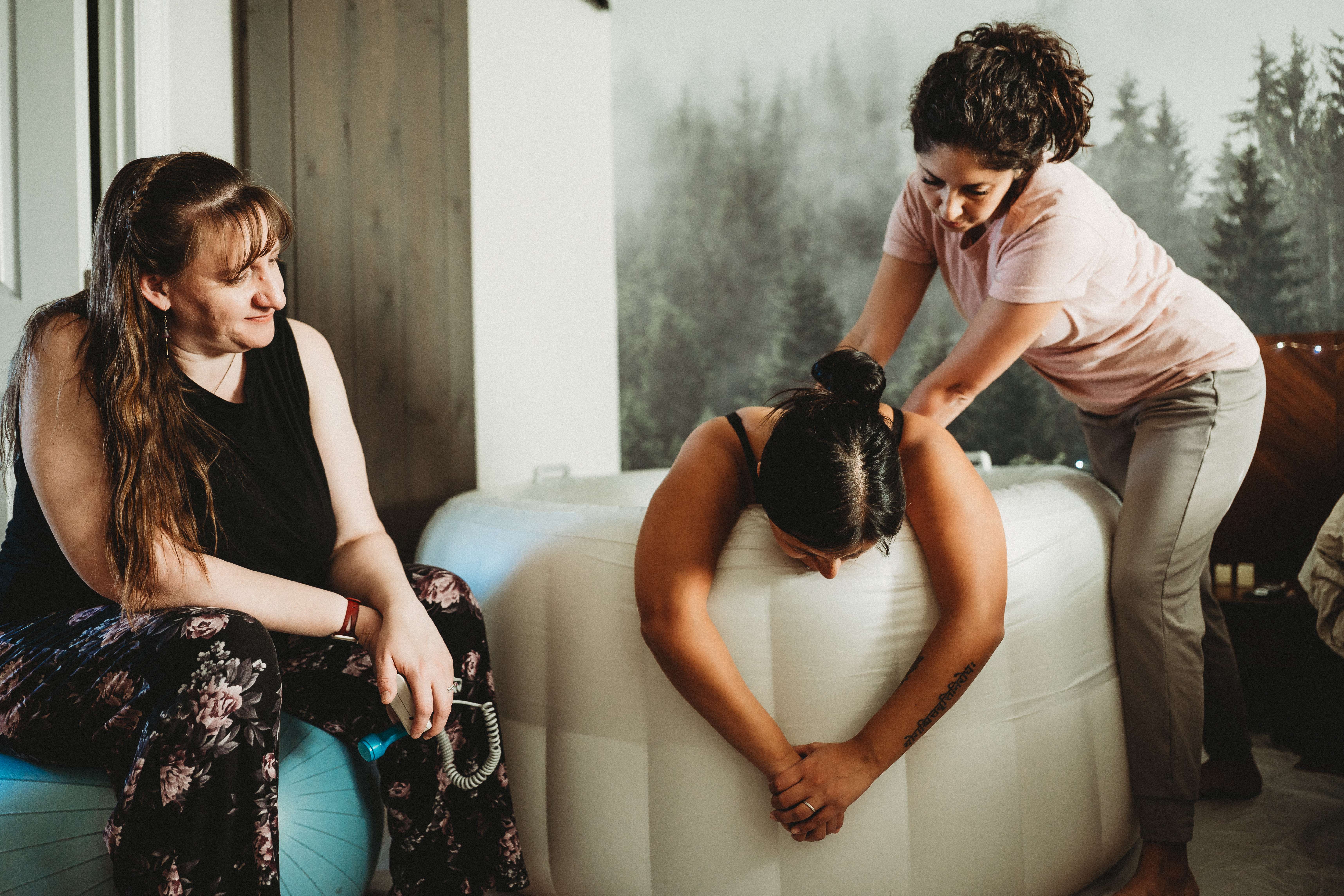 Maribel supporting a laboring mother during a home birth