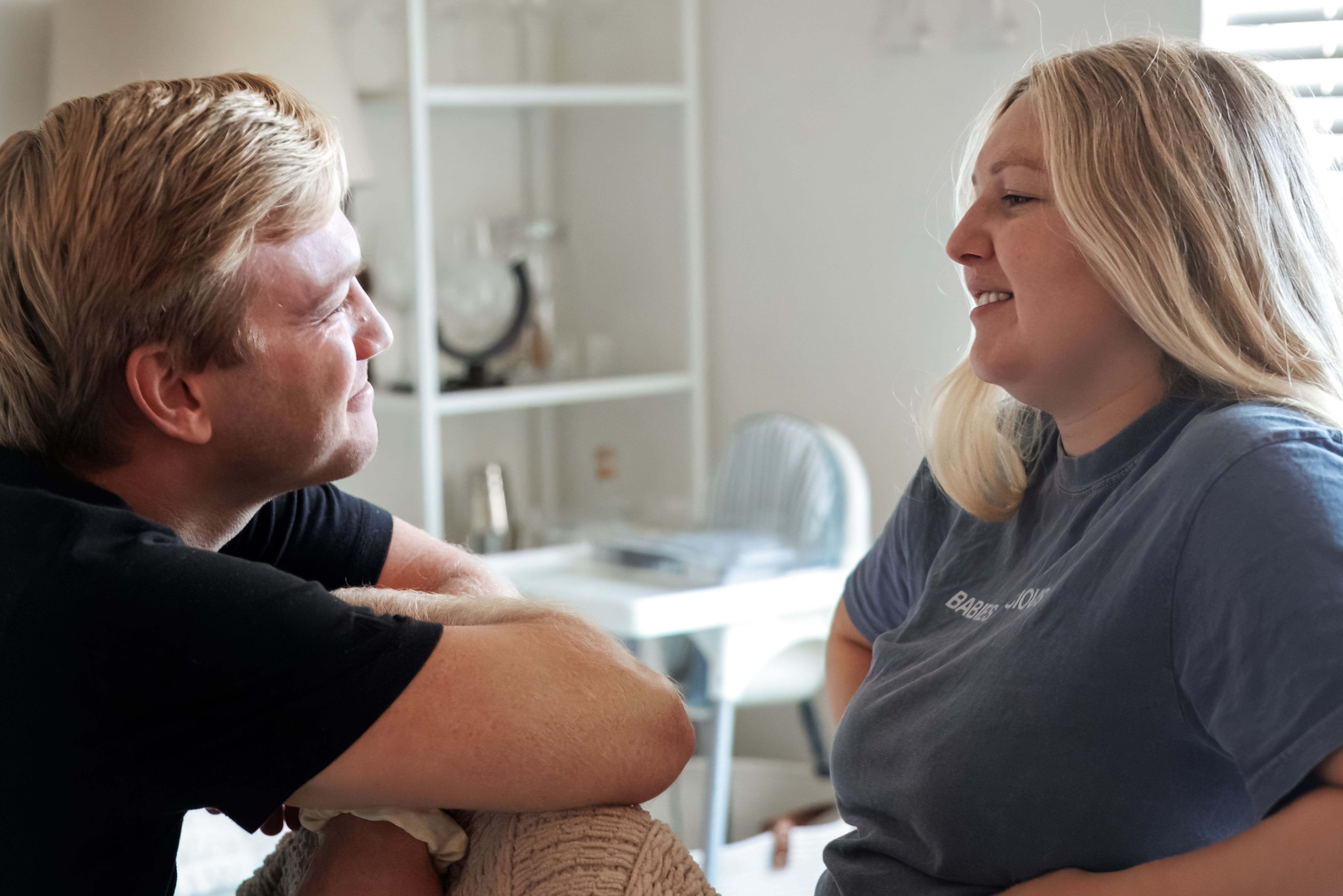 A couple smiling together during a prenatal visit